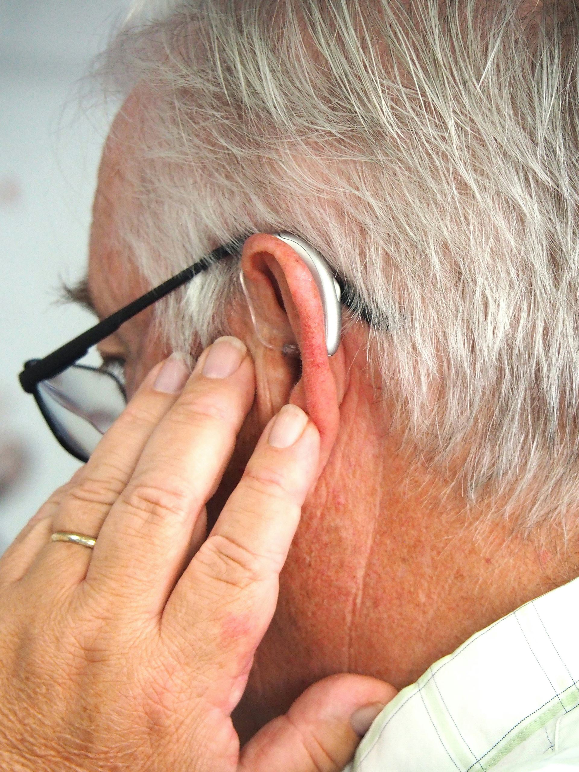 man with glasses & hearing aid