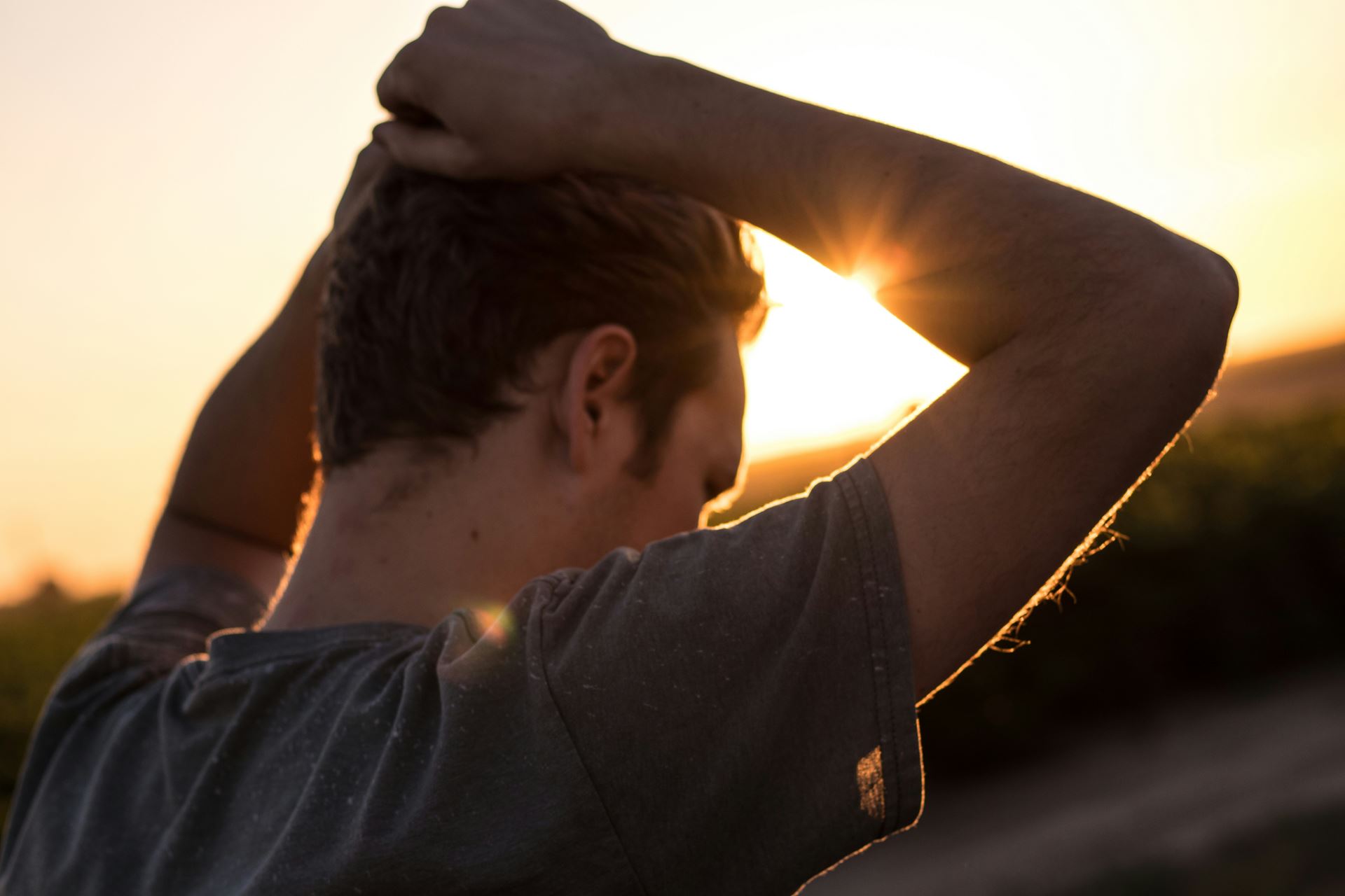 man with hands on head